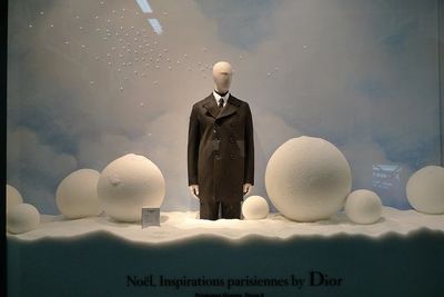 a mannequin dressed in a suit and tie stands in front of a display