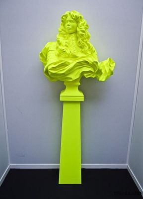 a yellow sculpture of a bust of a woman