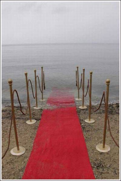 a red carpeted path leading to the ocean