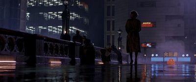 a man standing on a sidewalk in the rain