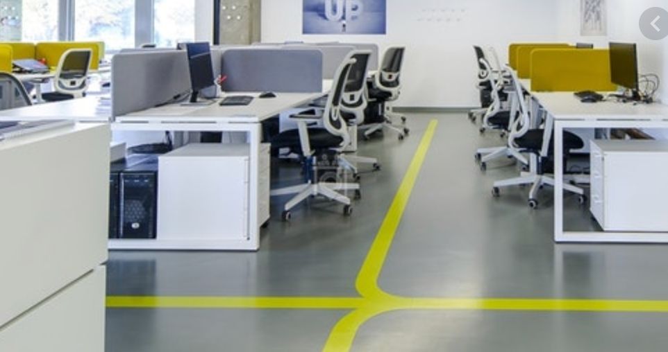 an office with a yellow line painted on the floor