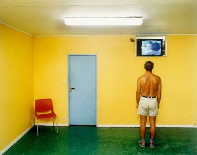 a man standing in front of a tv in a room