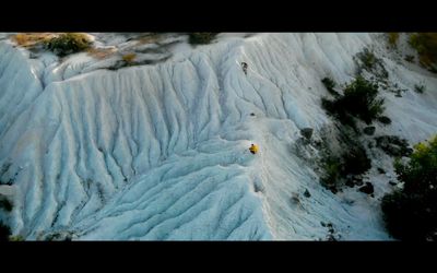 an aerial view of a man skiing down a mountain