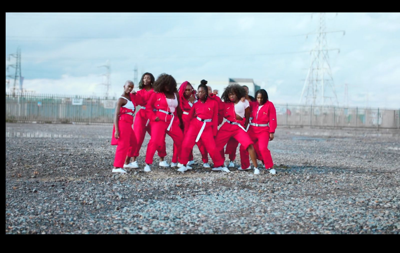 a group of women in red outfits standing next to each other