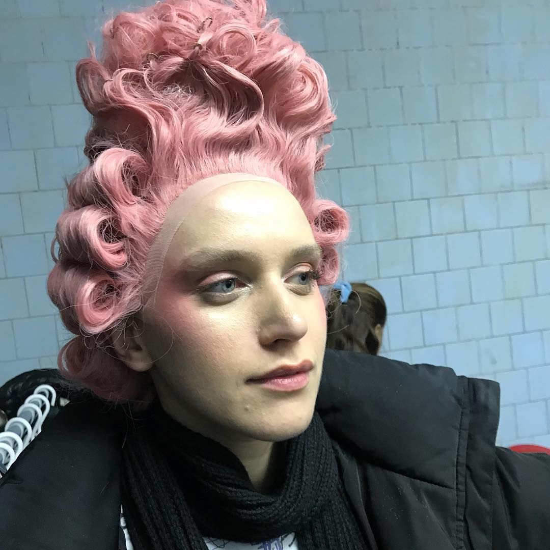 a close up of a person with pink hair