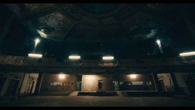 an empty auditorium with lights on the ceiling