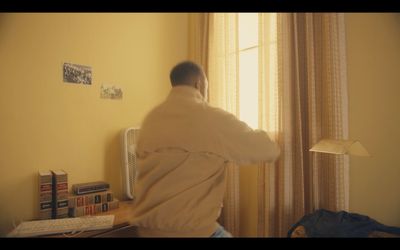 a man standing in front of a window in a room