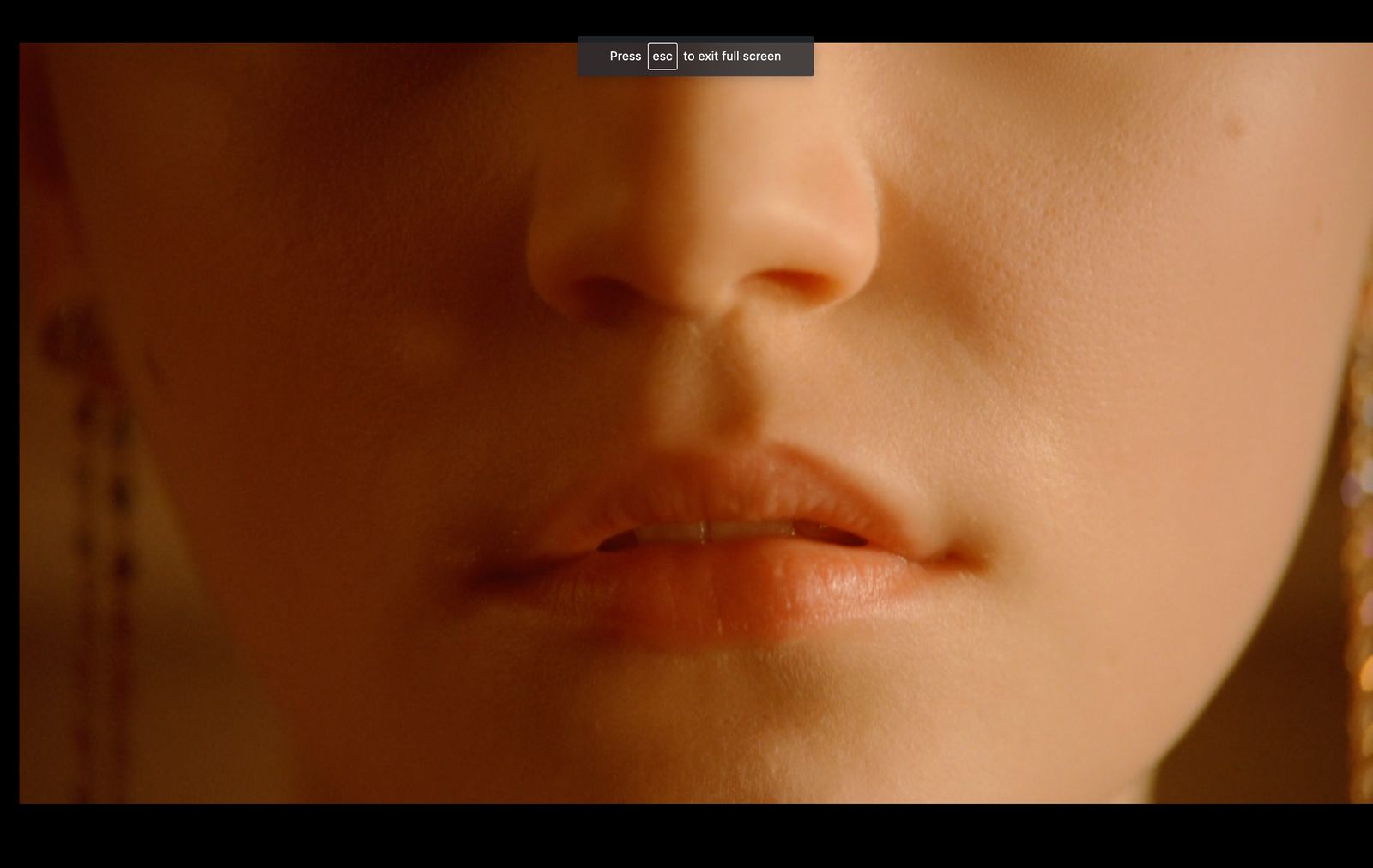 a close up of a woman's face with earrings