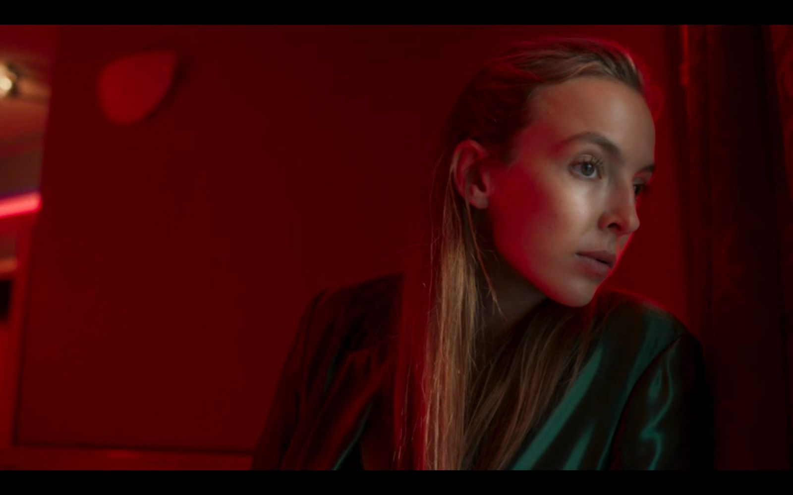 a woman standing in a room with a red light