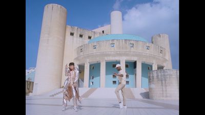 a couple of people that are standing in front of a building