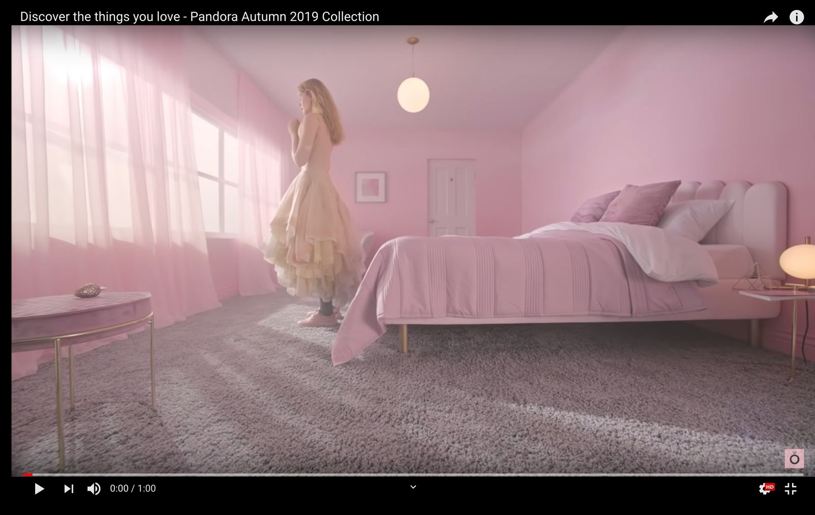 a woman standing in a pink bedroom next to a bed