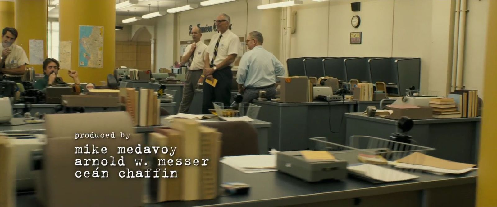 a group of men standing in an office