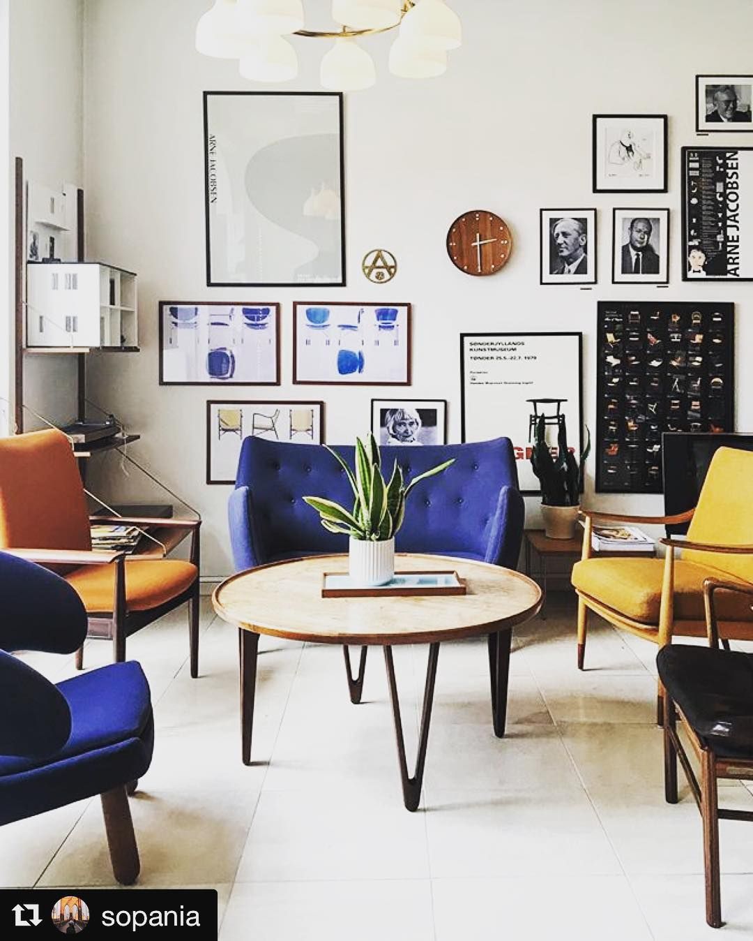 a living room filled with furniture and pictures on the wall