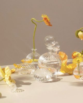 a group of glass vases with flowers in them