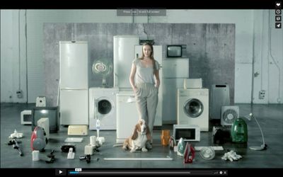 a woman standing in front of a bunch of appliances