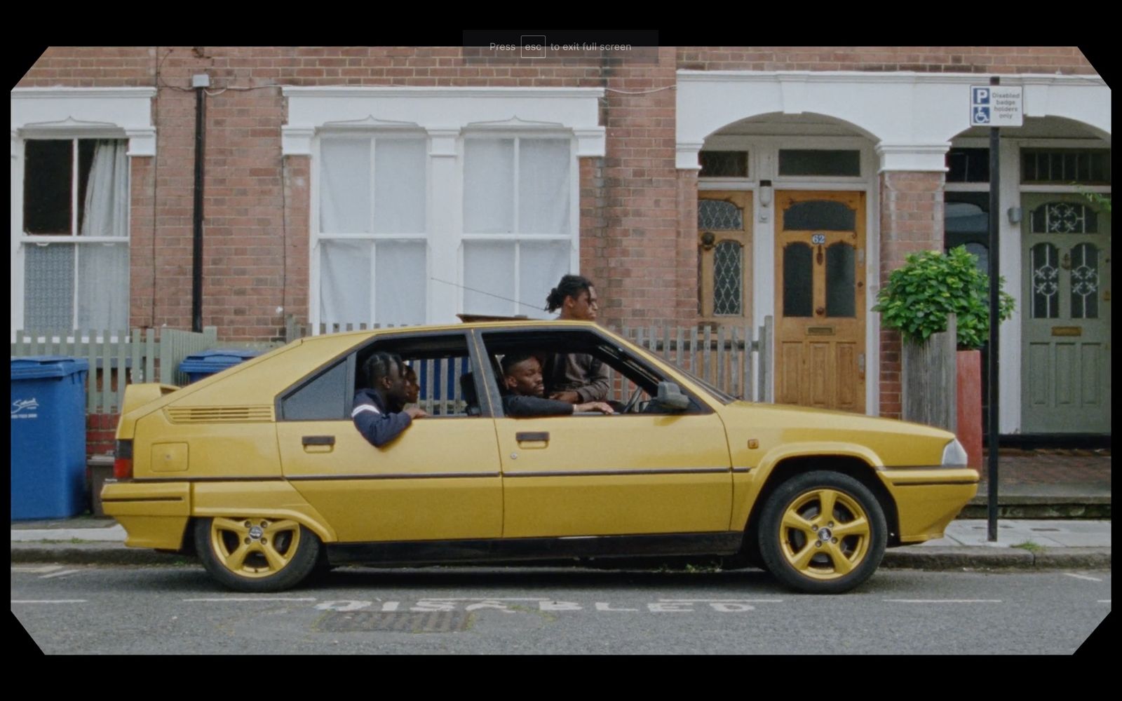 a yellow car parked on the side of the road