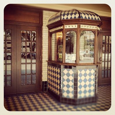 a checkered kiosk sitting outside of a building