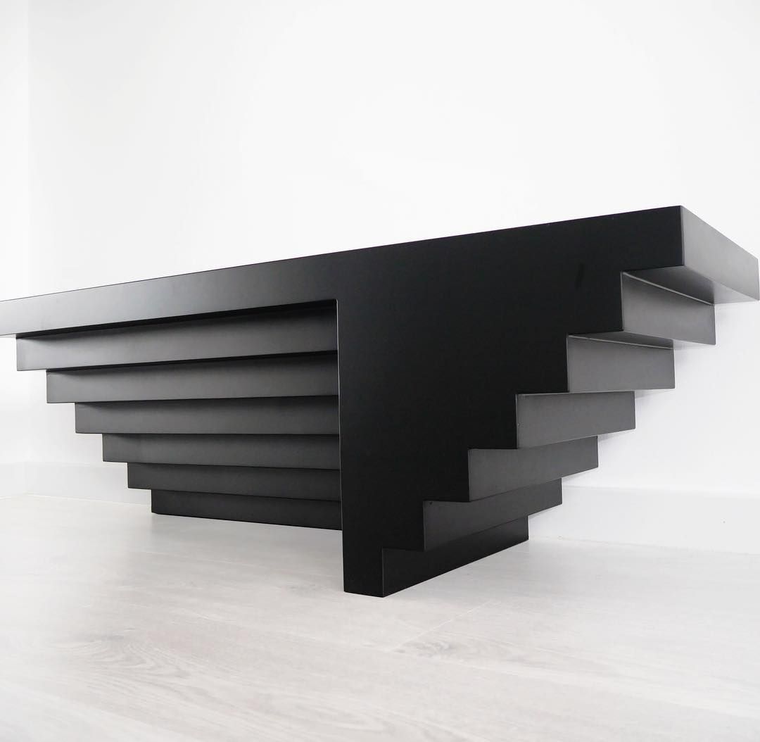 a black table sitting on top of a white floor