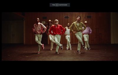 a group of men in white pants and red shirts