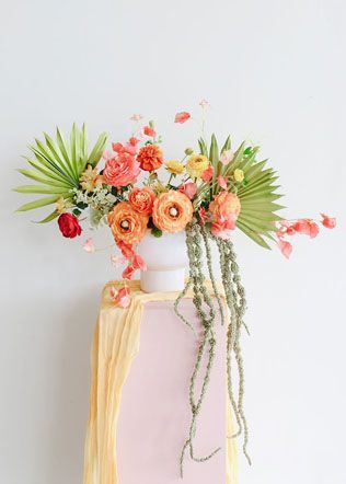 a vase with flowers on top of a table