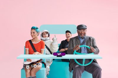 a group of people sitting around a table with a steering wheel