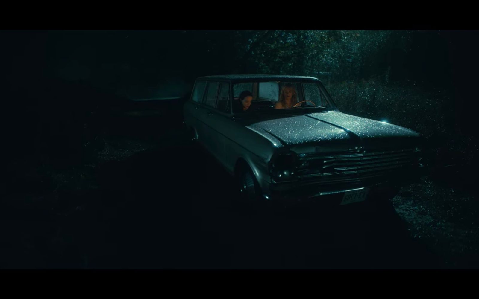 a car in the dark with two people in it