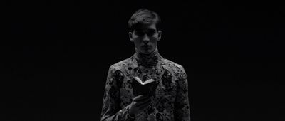 a man in a black and white photo holding a book