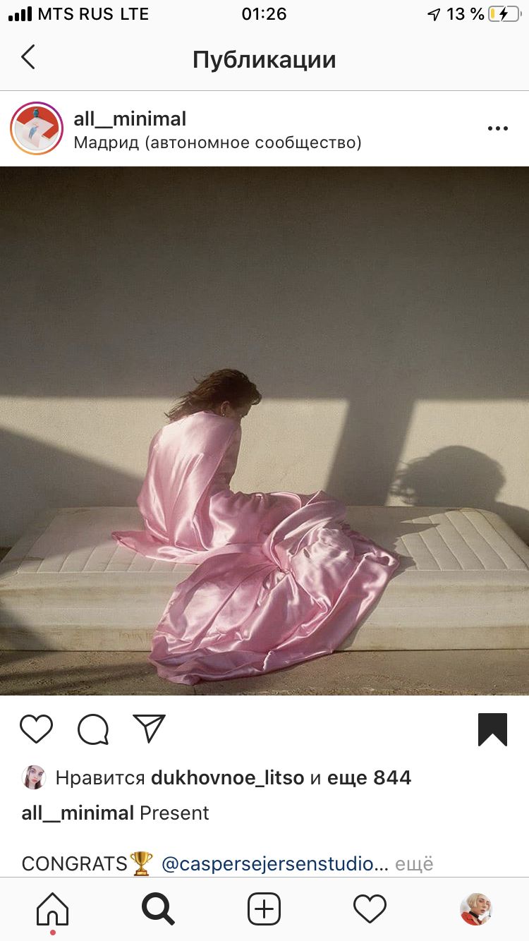 a woman in a pink dress sitting on a mattress