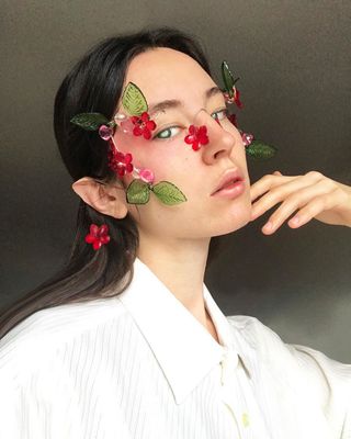 a woman with flowers painted on her face