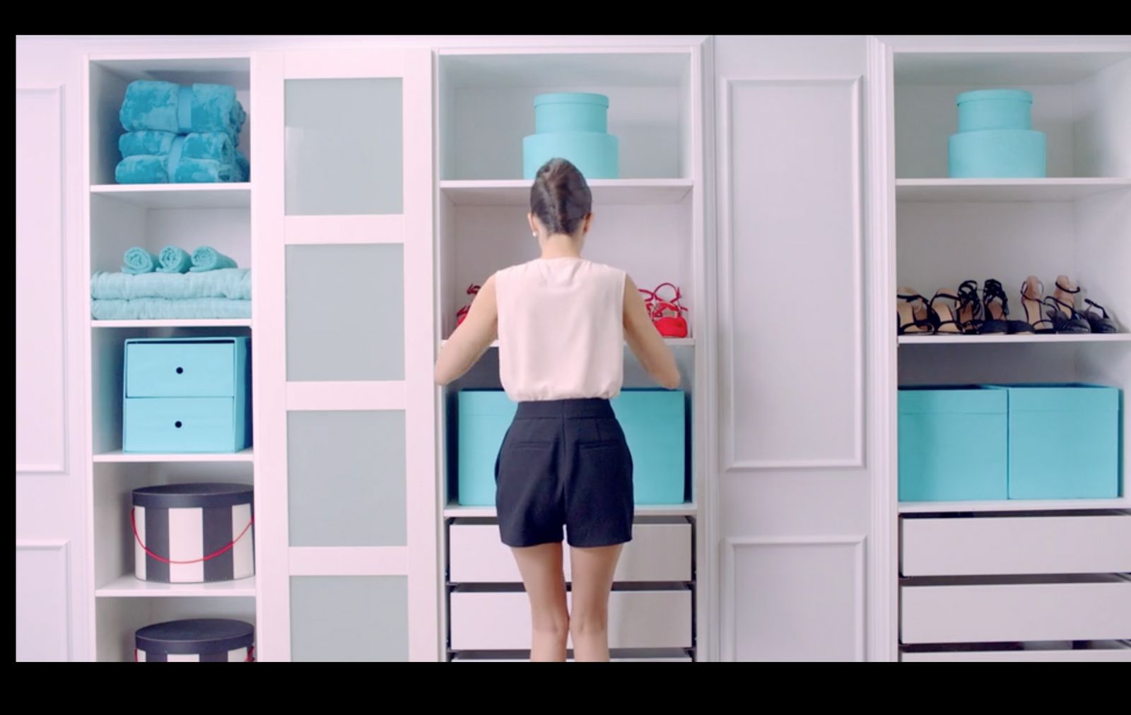 a woman standing in front of a book shelf