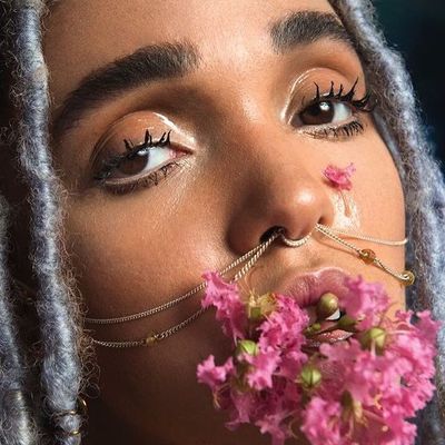 a woman with a flower in her mouth