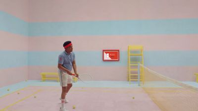 a man holding a tennis racquet on top of a tennis court