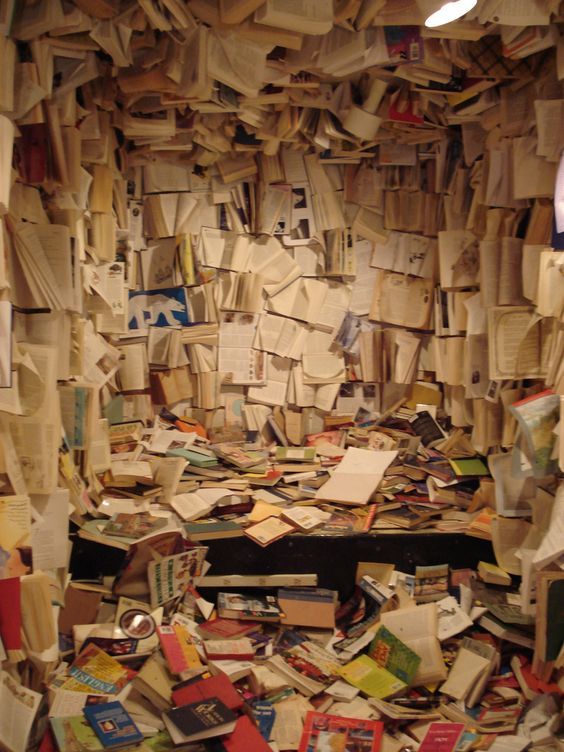 a room filled with lots of books and papers