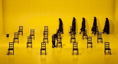 a group of people sitting in chairs in a room