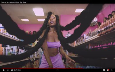 a woman with long hair standing in a store