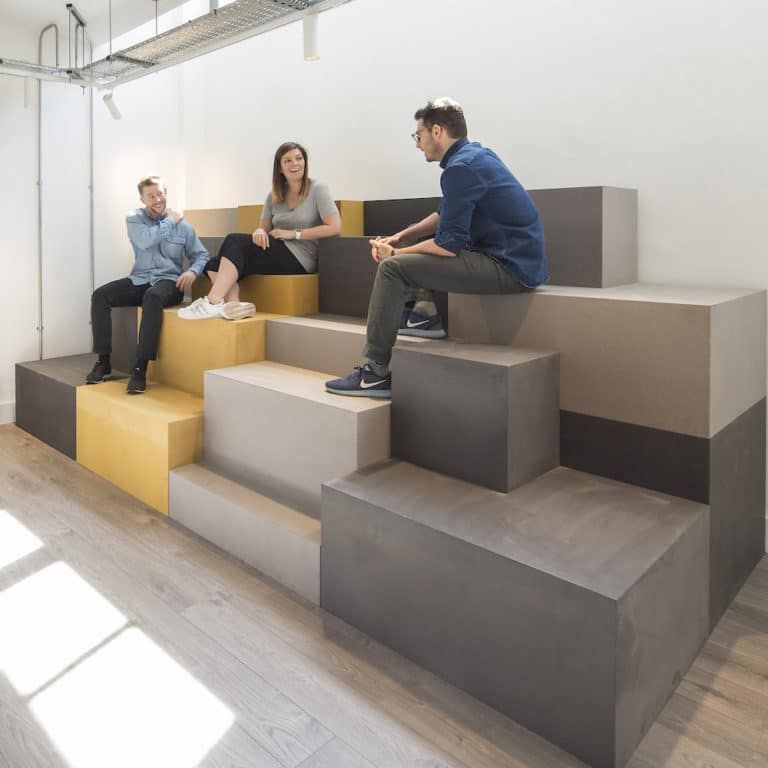 a group of people sitting on top of a set of stairs