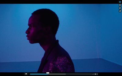 a man standing in a room with a blue light