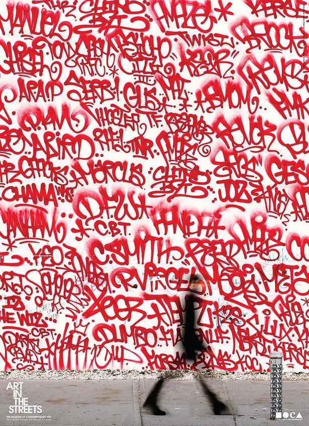 a person walking past a wall covered in graffiti