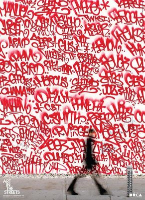 a person walking past a wall covered in graffiti