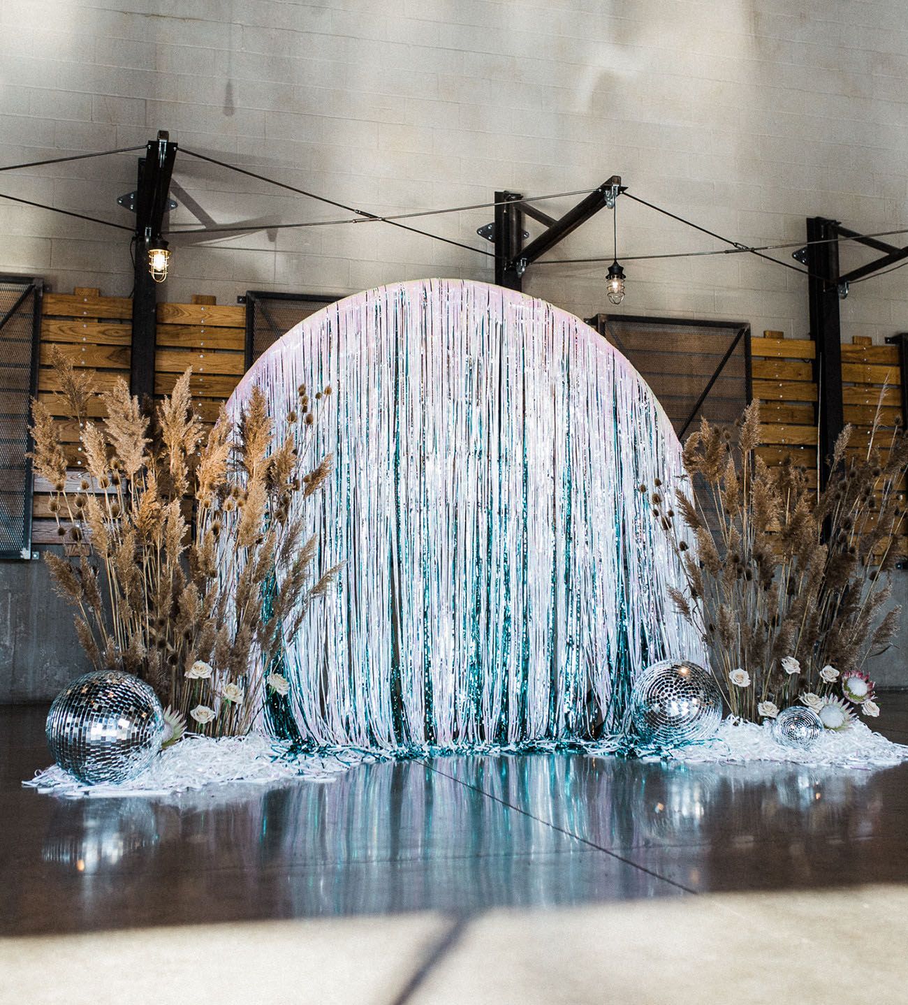 a water fountain surrounded by plants and snow