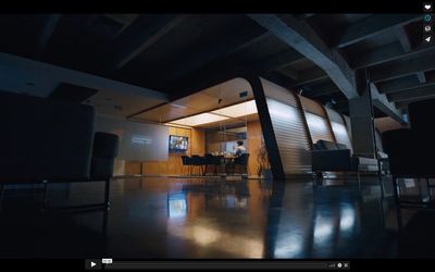 a dark room with a person sitting at a table