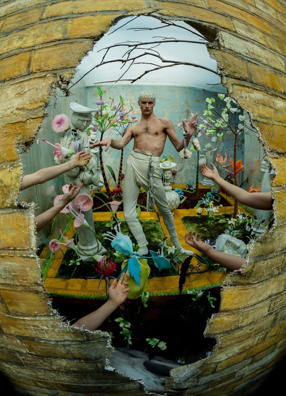 a man standing on top of a table surrounded by flowers