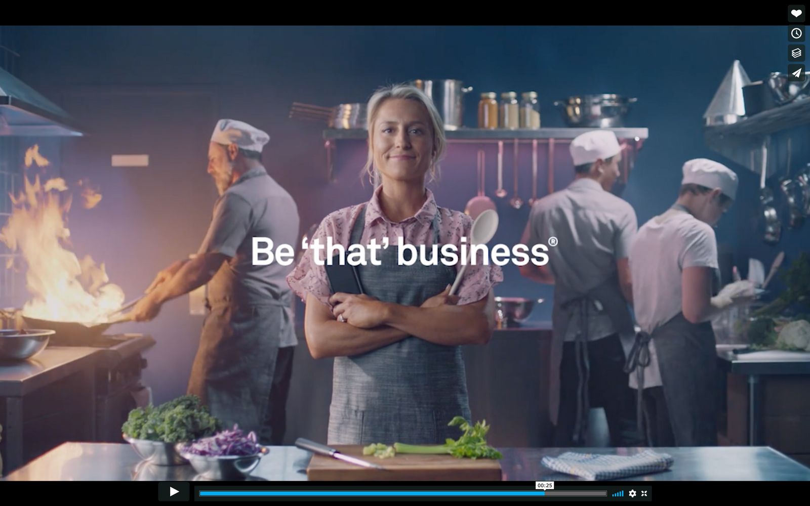 a woman standing in a kitchen with her arms crossed