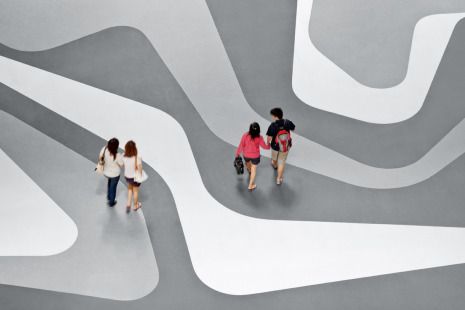 a group of people walking down a street next to each other