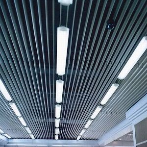 a large room with a ceiling made of metal pipes