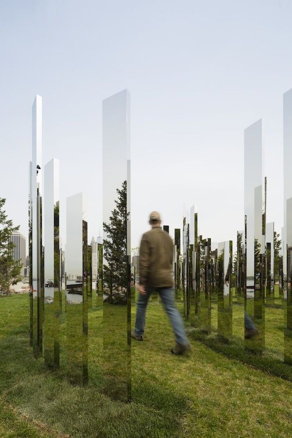 a man walking through a field of grass