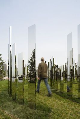 a man walking through a field of grass