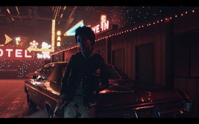 a man standing in front of a car in a motel