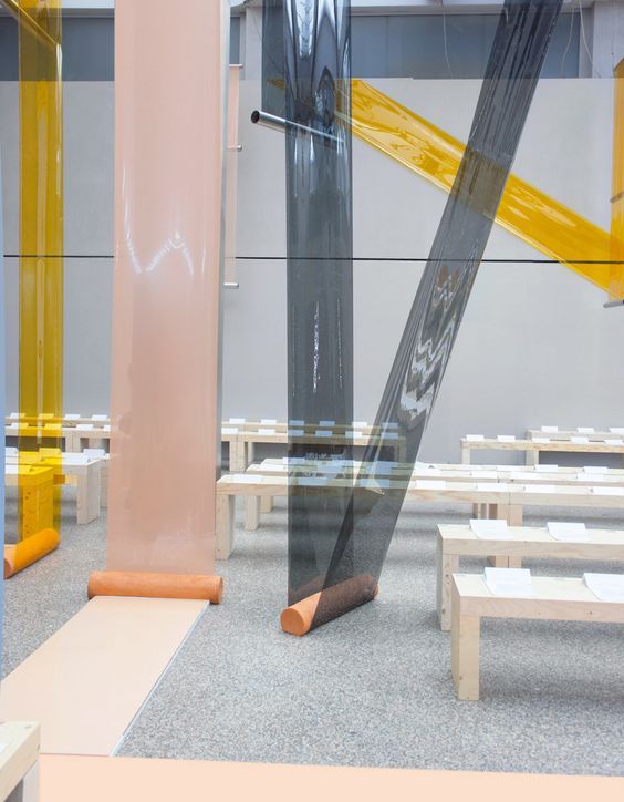 a room filled with benches and tables covered in plastic