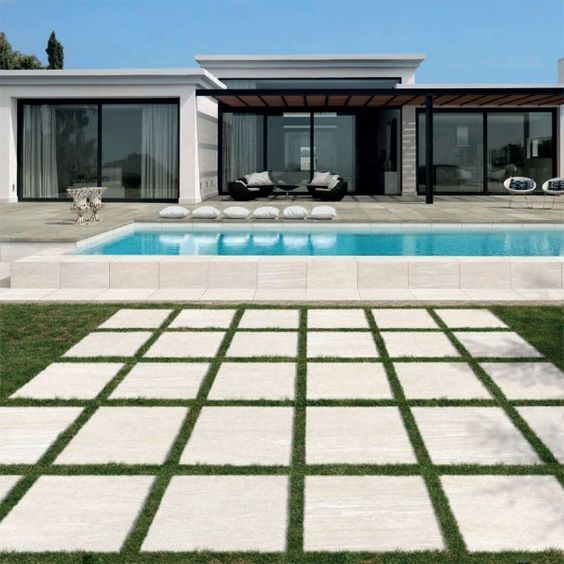 a modern house with a swimming pool in the yard